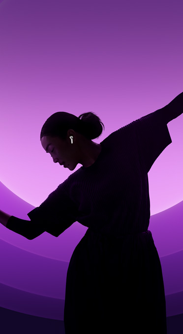  A silhouette of a woman dancing in AirPods Pro.