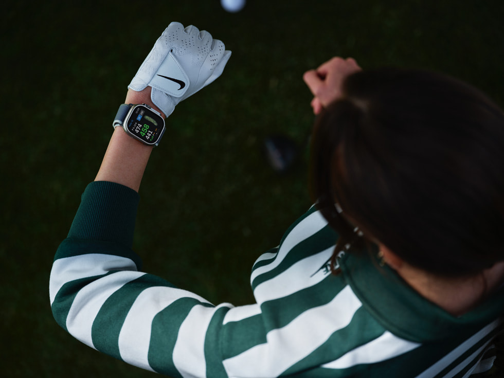一名高尔夫球手查看 Apple Watch 的俯瞰图。