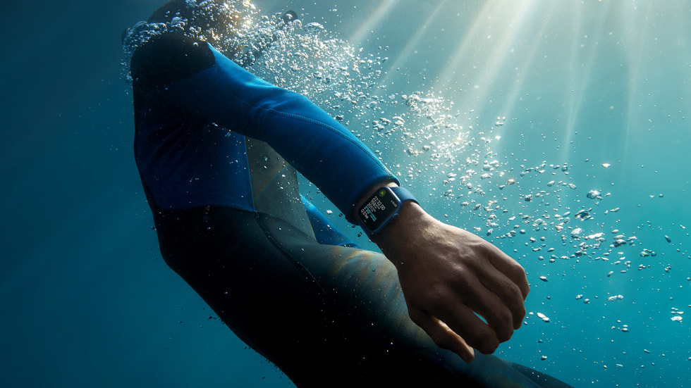 海上的一名冲浪者看着手腕上的 Apple Watch Series 7。